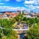 Aerial view of downtown Greenville South Carolina with Falls Park on the Reedy, Liberty Bridge, and surrounding real estate